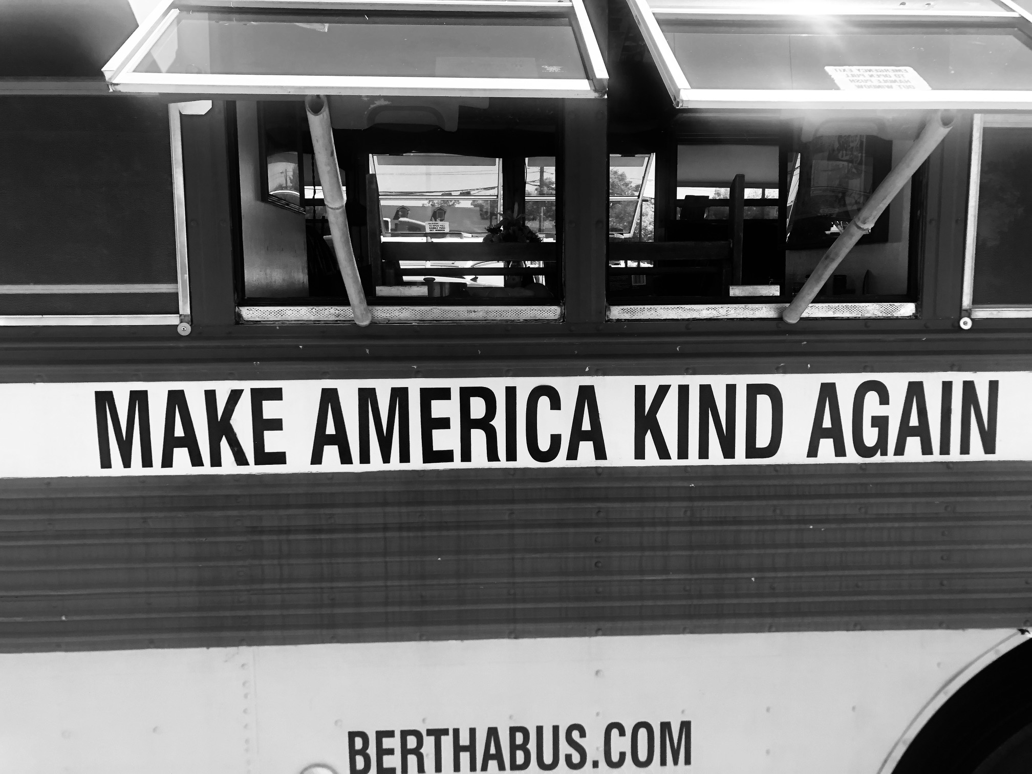 A bus with the words Make America Kind Again on the side.