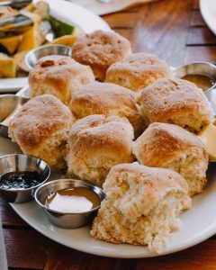 A plate full of fluffy golden biscuits